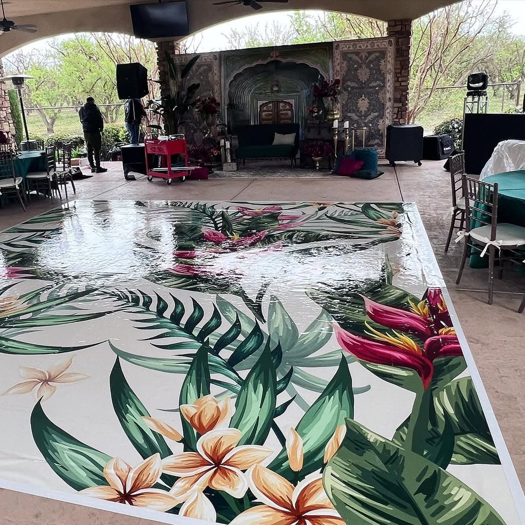 Bird-of-paradise and monstera dance floor rental photographed across its full width
