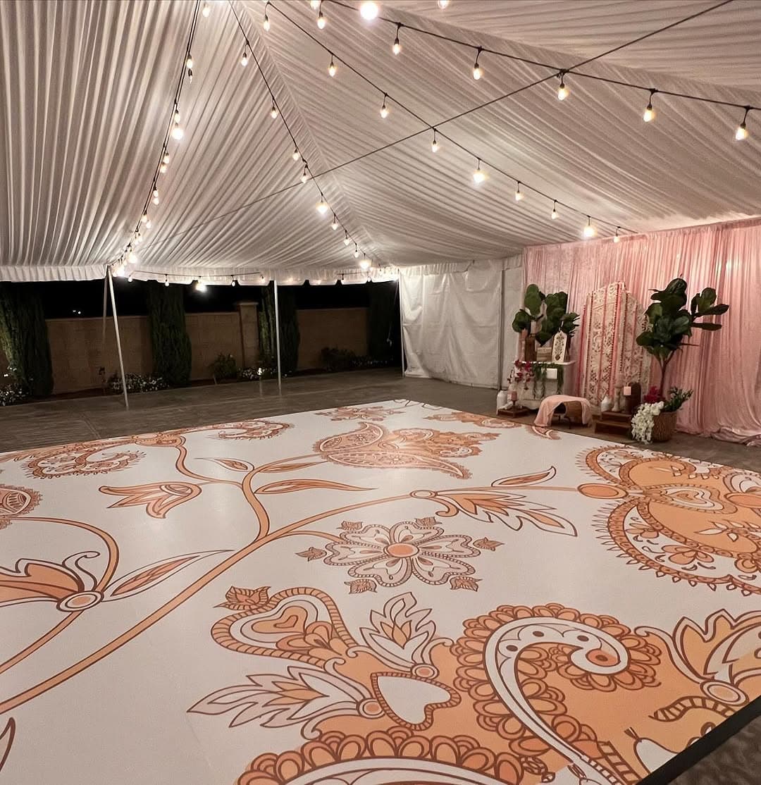 Paisley dance floor rental filling the centre of a draped marquee