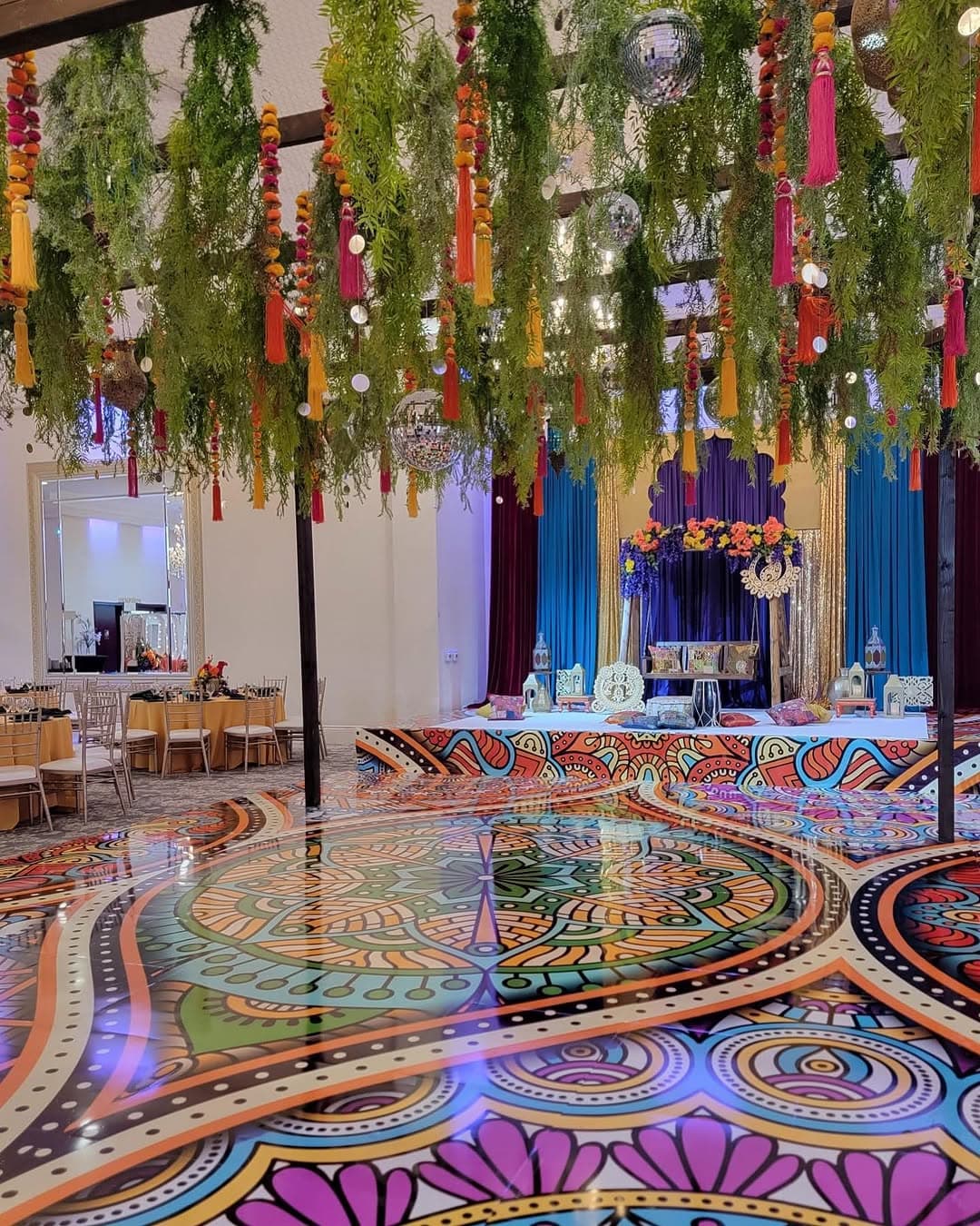Mirror-gloss mandala dance floor rental reflecting the lighting above it
