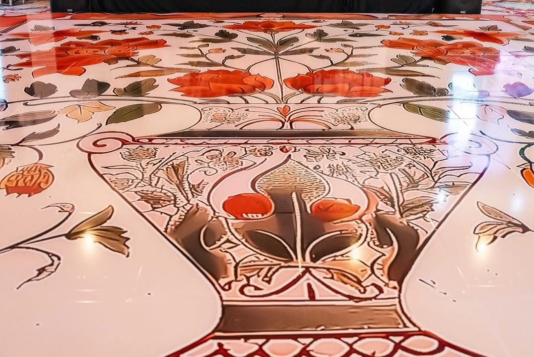Close view of the printed artwork on a coral and cream dance floor rental